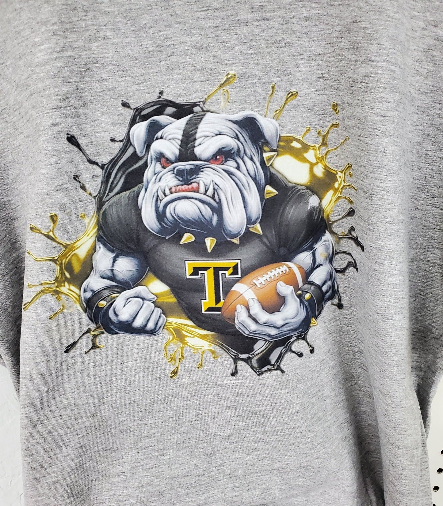 Bulldog football - tough looking bulldog holding the football - athletic wear, spirit wear